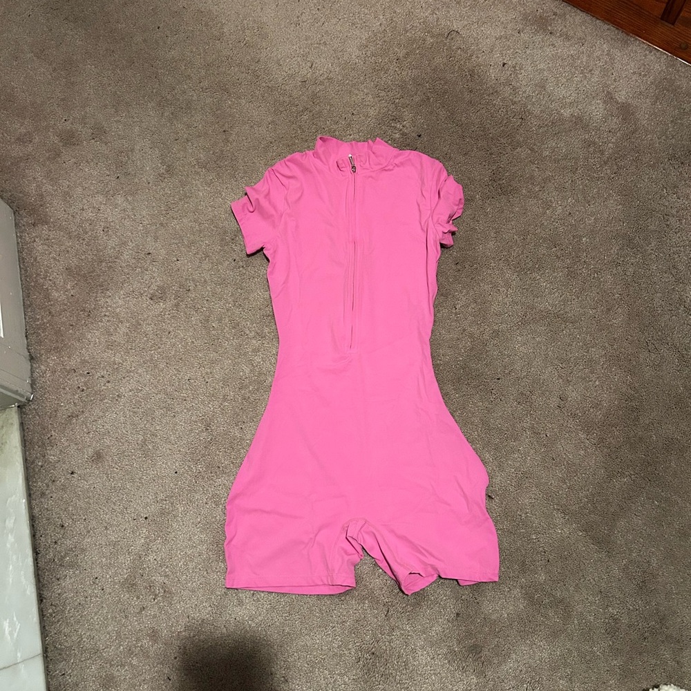This is a bright pink romper in a size medium in women's.